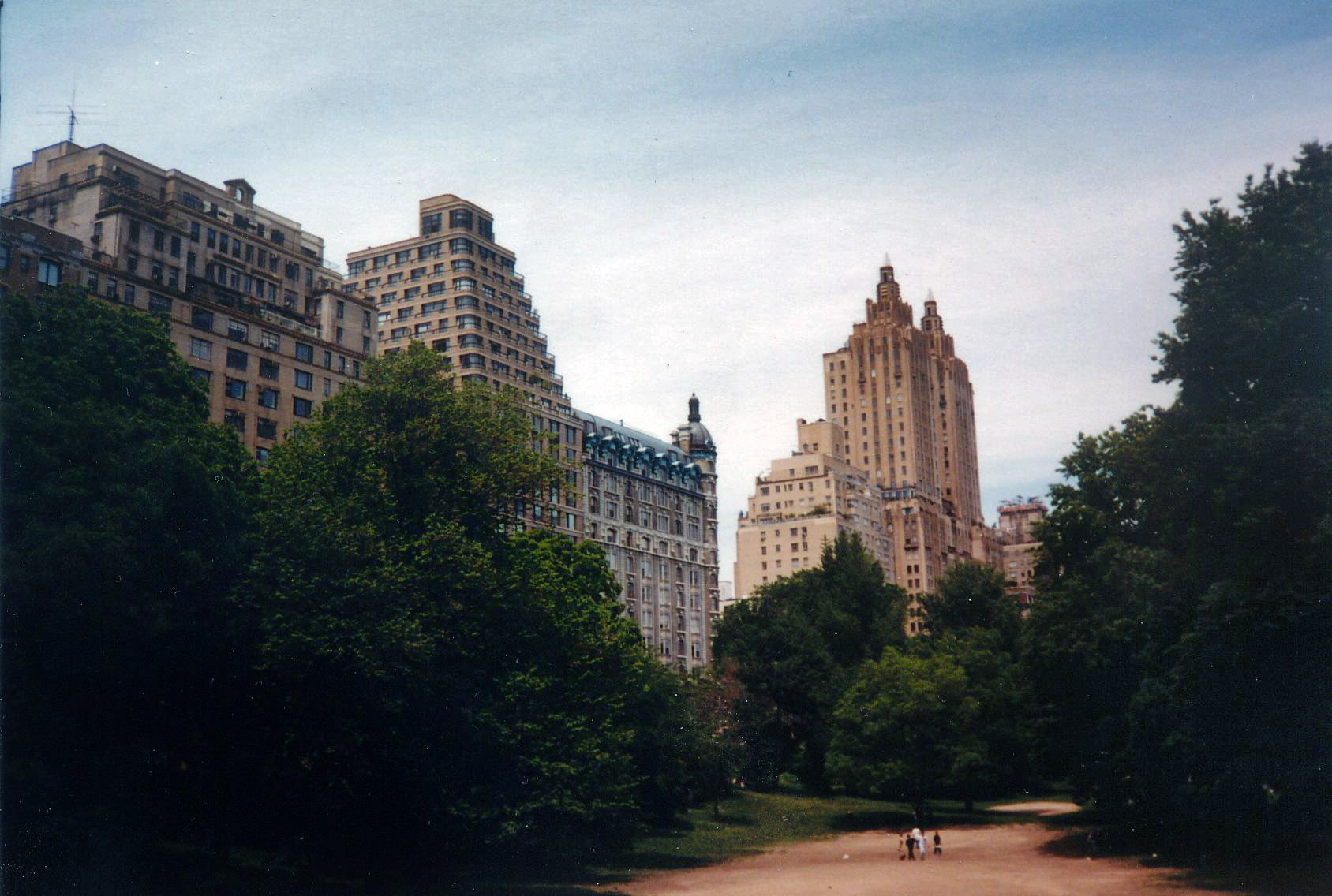 I took this on my first trip to New York City in May 1999. A lot of photos were taken in my 4 days I was there, but this was my favorite, I don't know why but the photo seemed to come out so cool looking, the buildings looming over the trees. 