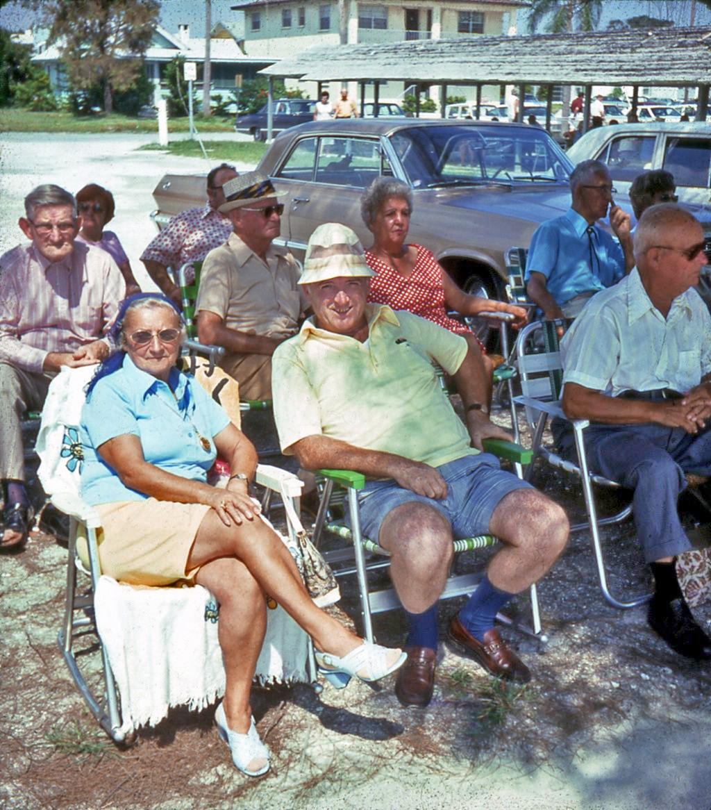 Unknown date and location of this slide I had found years ago and finally got scanned. I am thinking these folks are part of an audience for a parade, or some other outing. Judging by the cars in the back, mid-60's. View full size.