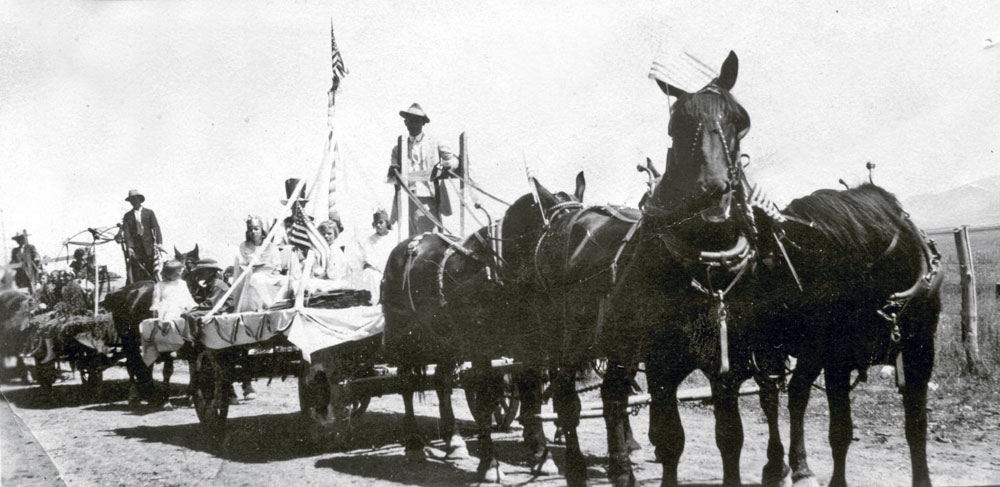 It looks like an old 4th of July parade, likely in Burley, Idaho, which is my grandmothers birth place. The date is unknown. I feel bad for street sweepers who have to clean up the horse mess after all is said and done. View full size.