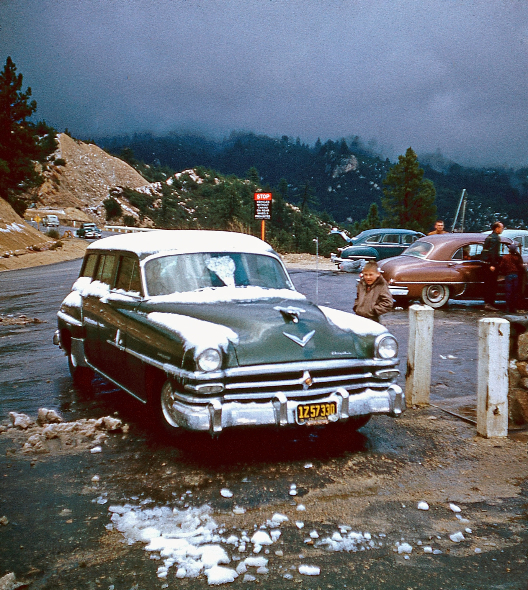 One half of a Kodachrome Stereo Slide marked "On the way up City Creek." This is somewhere on California state highway 30 (now 330), aka City Creek Rd., headed towards Running Springs, most likely to the cabin seen here. View full size.