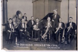 My father played the sousaphone in this picture but he played several instruments. I used to curl up inside this horn and toot. I must have driven my parents nuts. View full size.