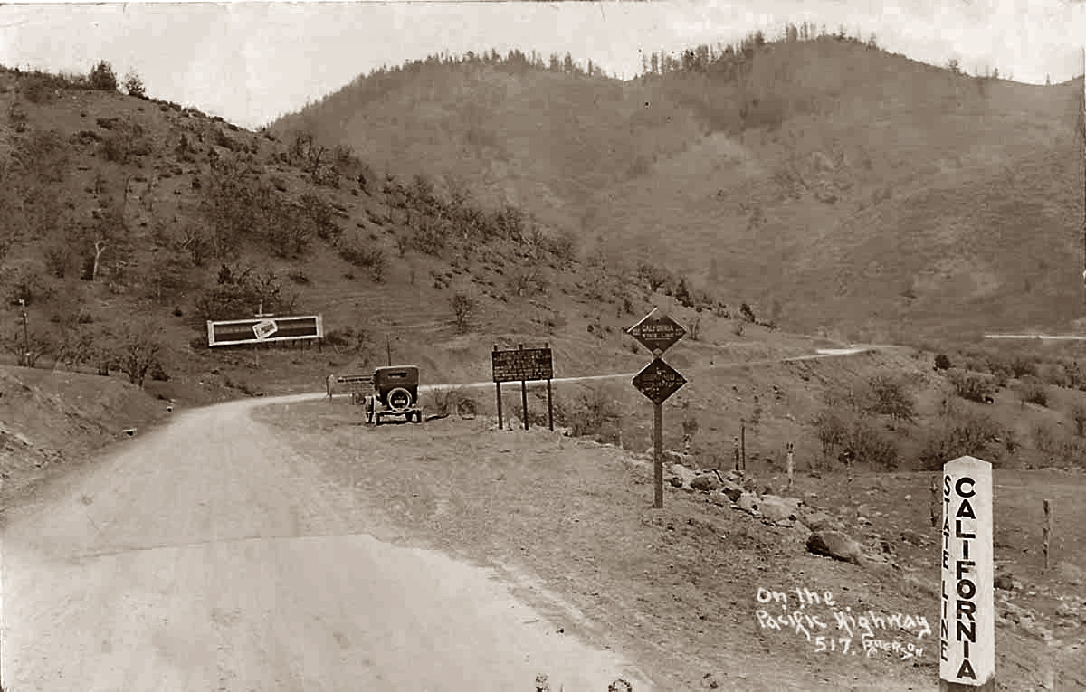 This is a postcard dated 1928 showing the Pacific Highway on the Calif.-Oregon border. Most likely Interstate 5 now. Looks like it's slow going on that gravel. No 65 mph on this road.  