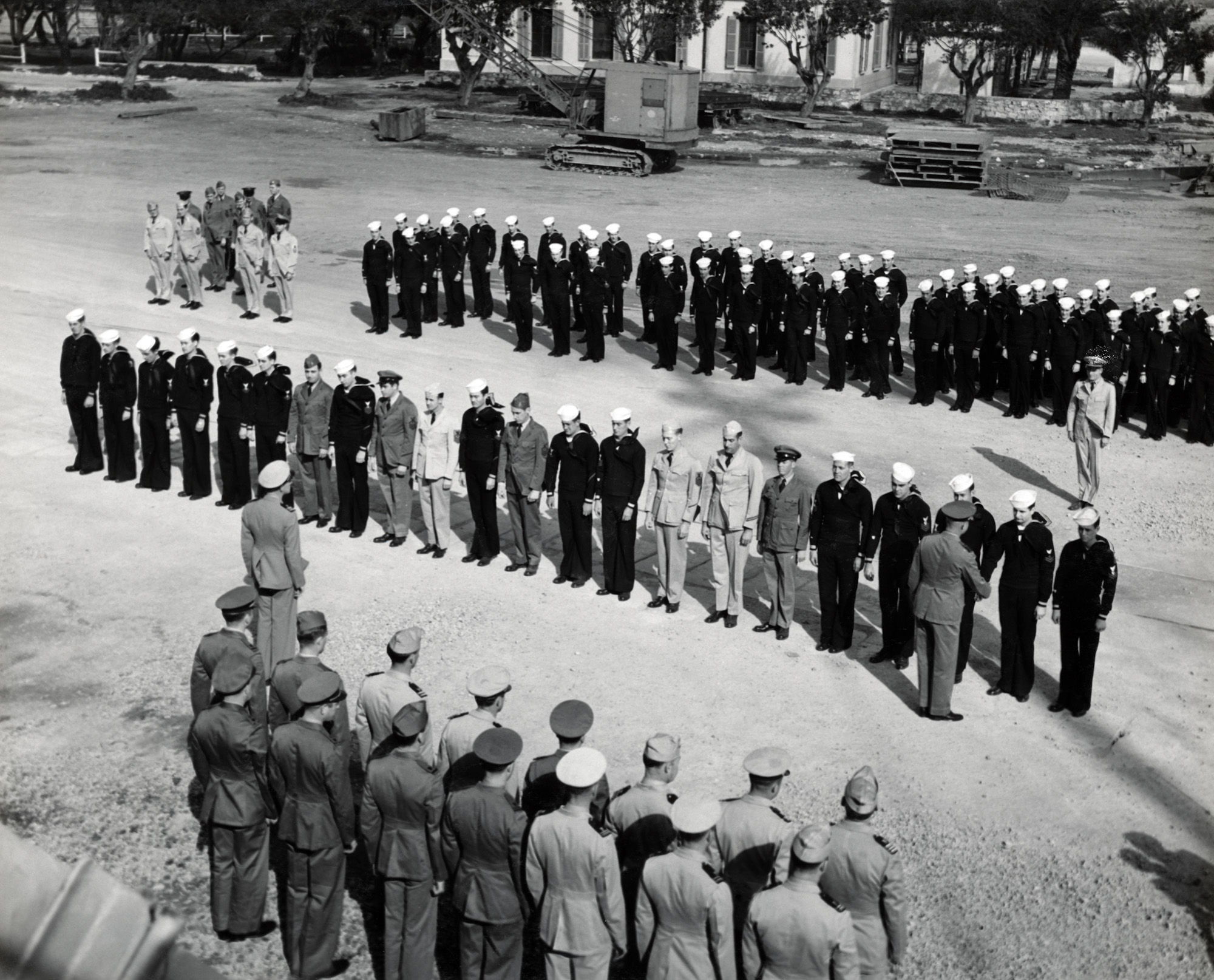 In this photograph Admiral H. Kent Hewitt of the 8th Fleet can be seen giving out awards to the heroes from the USS Duane. Admiral Hewitt was previously aboard the Duane where he and Admiral Lowry took part in “Operation Anvil-Dragoon” – the Allied invasion of Southern France. The USS Hewitt was later named after him and was in service from 1974 until 2001.

The man receiving the award in this photograph is this website’s namesake – Ph. M. John “Jack” Baker. It is believed that this photograph was taken by Dale Rooks. I am not sure if there are photos of each man being awarded their medals, or if Rooks just happened to take this one because my grandfather was his good friend. This was likely taken in early 1945 while the USS Duane was docked in Bizerte, Tunisia.

If anyone has any more information, or can identify any of the other men in this photograph, please contact me.

This photograph comes from my grandfather John "Jack" Baker's Warbook, which contains over 150 original photographs. I have been scanning them all at 1200dpi and submitting them here for Shorpy readers. View full size.