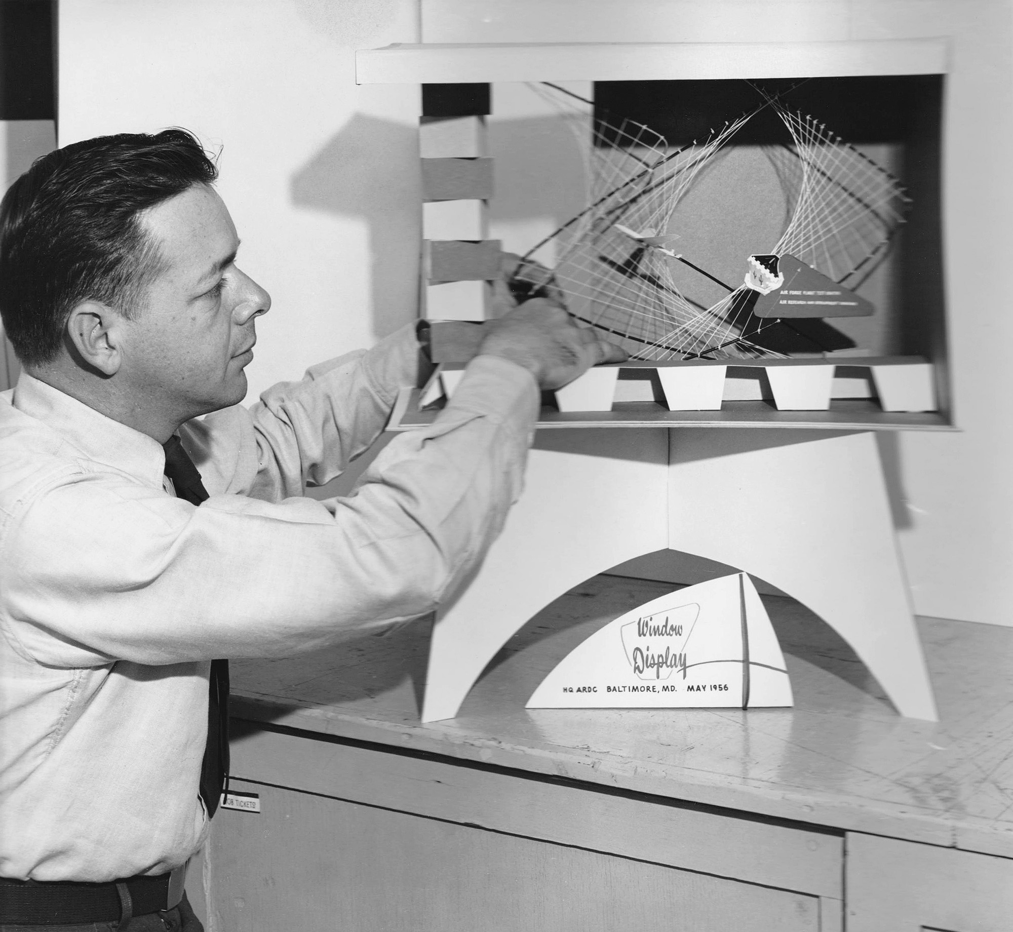 My Dad, Gordon Clevenger,at Edwards AFB, California, circa 1962, with one of his designs. He got his first job in a sign shop in Chicago, Illinois, as a young boy, and was still working as a "sign man" up until his death in 2002. He retired from the Air Force in 1963 after serving in WWII and Korea. View full size.