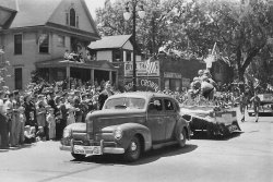 Memorial Day 1948 Madison, Wisconsin.  WW 2 Vets on float only 3 years after the war. View full size.
The carsA 1940 Nash Ambassador Eight Sedan in front, followed by a 1947 Cadillac.
Close, but wrong holidayThis was actually Statehood Day, marking Wisconsin's centennial. There was no Memorial Day parade that year because it was only a few days away from Statehood Day. For Madison people seeing this, the location is the last block of State Street, where the University Book Store and Memorial Library now stand. All those buildings in the picture are gone.
(ShorpyBlog, Member Gallery)