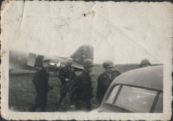 Image taken in England. The picture shows Generals Eisenhower, Patton, Bradley and Hodges getting into a car. View full size.