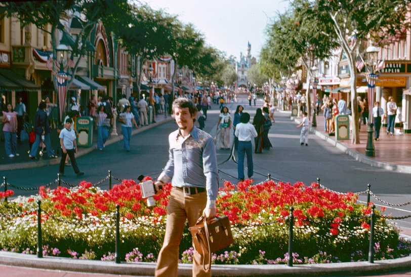 Main Street, USA in Disneyland, that is, where my friend has captured me on Kodachrome with bell-bottoms billowing and armed with Super-8 camera. I didn't know this photo existed until a few days ago when he and I discovered a cache of slides in a forgotten box at his place. In fact, I'd totally forgotten we'd taken this Southern California road trip at all. Much to his amusement. View full size.
