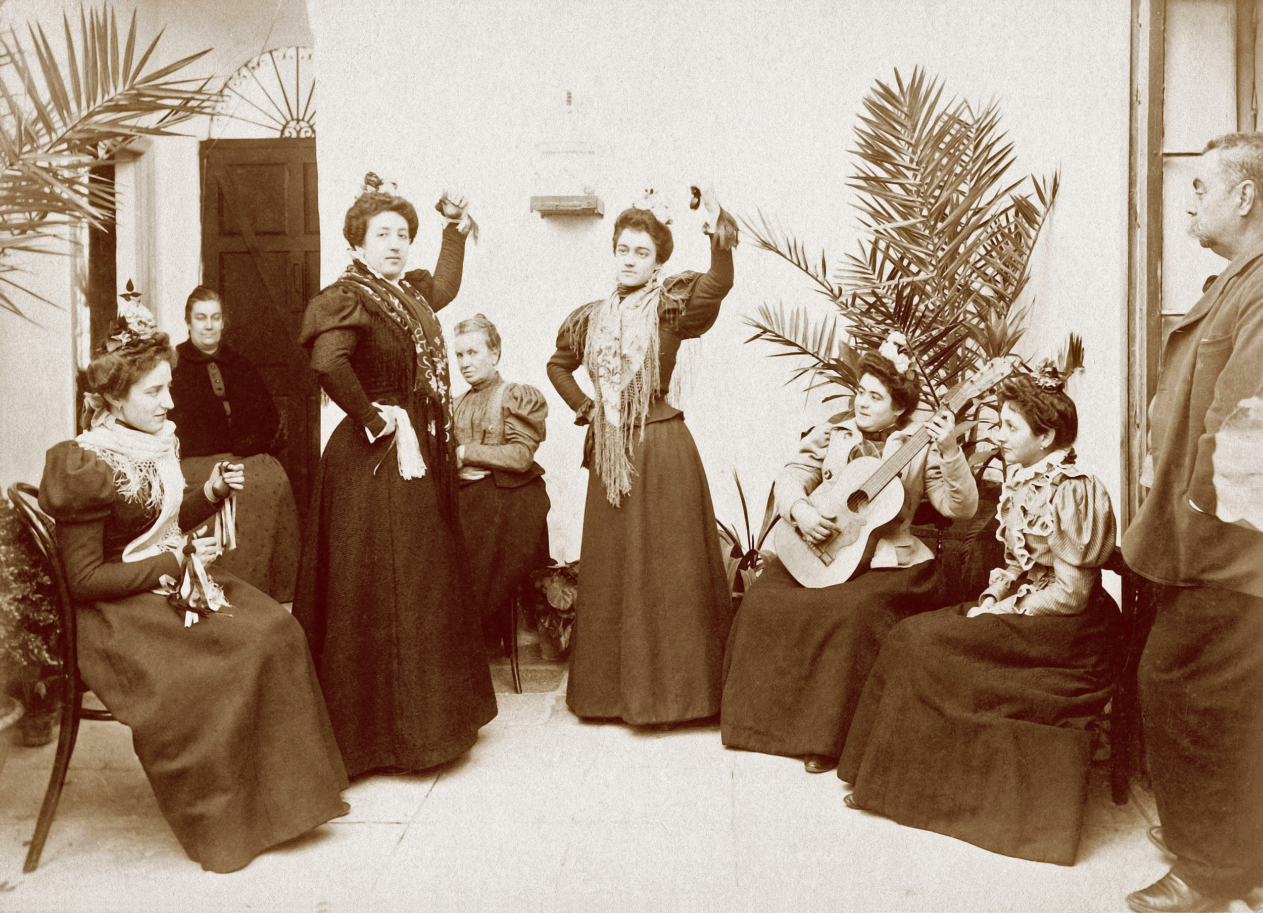 A group of young ladies posing as dancers in Jerez de la Frontera, province of Cadiz, Spain, circa 1900. My great-grandmother is sitting first from the right. View full size.
