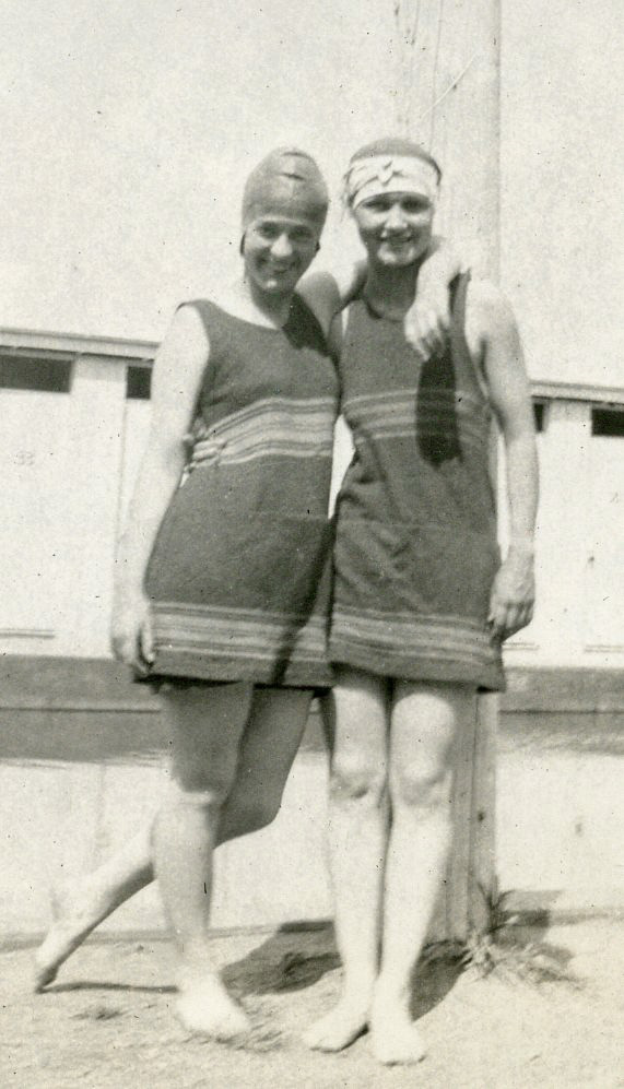 Fifteen years earlier it would have been simply shocking for teen girls to be seen in public with so much skin exposed. But on the cusp of the Roaring Twenties, fashion had changed. Compared to the middy dresses of earlier bathers, this was nearly a bikini.

Photograph was taken by Christine Bader some time between 1919 and 1921. I found it in a photo album she made during her high school years. On the back is a purple rubber stamp with a triangular logo featuring the graphic of a native American in feather headdress, and the words Illini Quality Service. This suggests, that though she took the photos, she sent them out for commercial processing.
 