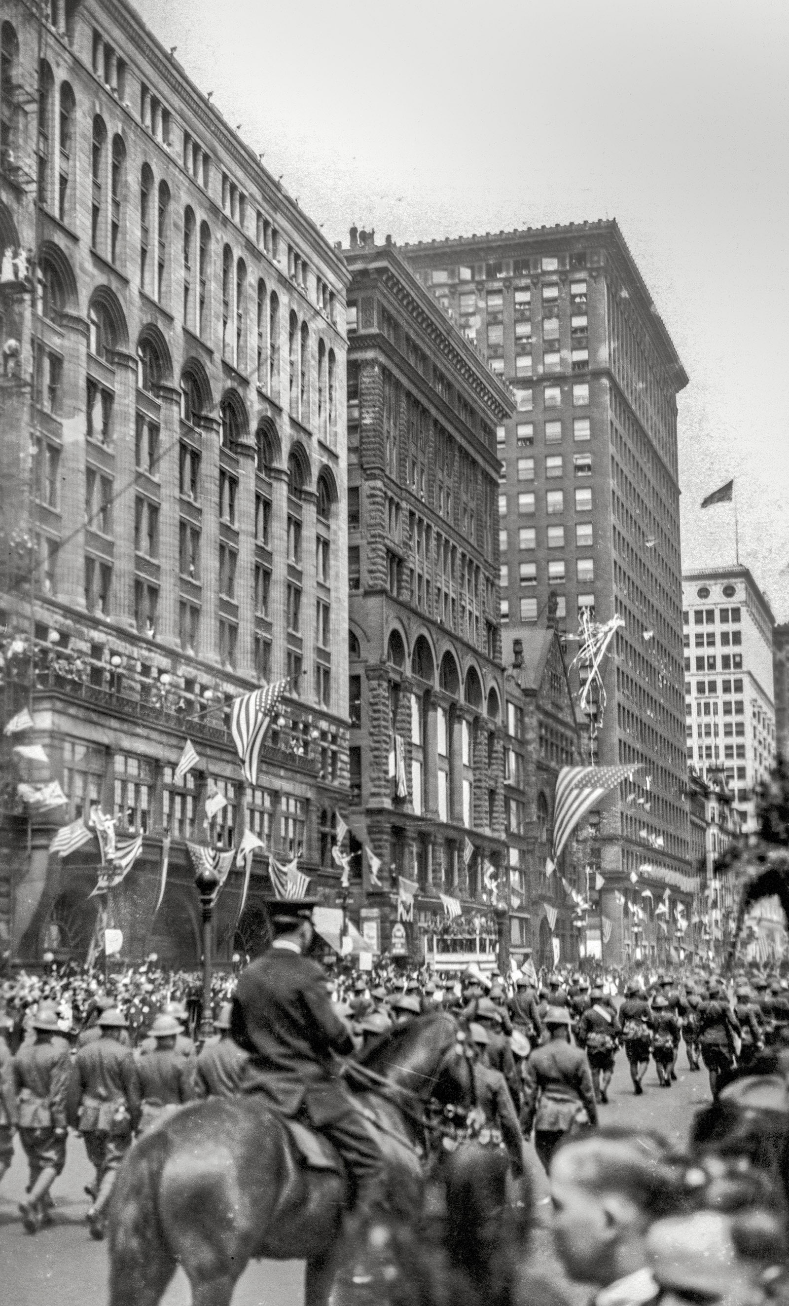 Chicago, May 12, 1919. "Return Parade for the 13th Railway Engineers, Michigan Boulevard." View full size. For another view, click here.

&nbsp; &nbsp; &nbsp; &nbsp; Thirteenth Engineers Returns to Chicago. The greatest reception given to any organization of returning soldiers at Chicago was given to the 13th Railway Engineers on May 12. Its welcome to its home town was unequaled in point of enthusiasm and spectacular expression in the after war history of the city. Approximately 100,000 people banked Michigan Boulevard on both sides and maintained a bedlam of noise as the regiment paraded in platoon formation. Employees of the six railroads centering in Chicago from which the 13th Engineers was mainly recruited were organized in groups along Michigan Boulevard to welcome the men.
-— Railway Age and Railway Review, 1919

During World War I, the regiment known as the 13th Engineers consisted of personnel from the six largest railroads that ran through Chicago; it operated about 142 kilometers of French railways, serving the Verdun-St. Mihiel, Champagne-Marne, and Meuse Argonne sections. The scan is from a family photo album titled "My Vacation Days," with dates ranging from 1914 to 1922.