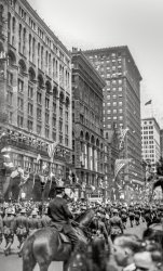 Chicago, May 12, 1919. "Return Parade for the 13th Railway Engineers, Michigan Boulevard." View full size. For another view, click here.
&nbsp; &nbsp; &nbsp; &nbsp; Thirteenth Engineers Returns to Chicago. The greatest reception given to any organization of returning soldiers at Chicago was given to the 13th Railway Engineers on May 12. Its welcome to its home town was unequaled in point of enthusiasm and spectacular expression in the after war history of the city. Approximately 100,000 people banked Michigan Boulevard on both sides and maintained a bedlam of noise as the regiment paraded in platoon formation. Employees of the six railroads centering in Chicago from which the 13th Engineers was mainly recruited were organized in groups along Michigan Boulevard to welcome the men.
-— Railway Age and Railway Review, 1919

During World War I, the regiment known as the 13th Engineers consisted of personnel from the six largest railroads that ran through Chicago; it operated about 142 kilometers of French railways, serving the Verdun-St. Mihiel, Champagne-Marne, and Meuse Argonne sections. The scan is from a family photo album titled "My Vacation Days," with dates ranging from 1914 to 1922.
Delayed ReturnI wonder if they really took this long from the end of the war to get back or if their skills were so sorely needed post-armistice that they had much work to do getting European railroads back into action again.
[It's the parade that was delayed. Because Chicago winters. - Dave]
Marching OrdersThe Michigan Avenue marchers are rapidly approaching the intersection of Michigan and E. Van Buren Street which would have crossed right in front of the tallest building in the picture to the left.
Except for the gabled building (4th from left-front) which has been replaced with a building which respects the design of the other two buildings to the left, all those buildings exist today, including the small 5-story building which now has a remodeled facade.
At the time of this parade, there would have been a railroad switch yard between Michigan Avenue and a much smaller Grant Park.  The tracks were subsequently lowered and covered over to make a much larger Grant Park which now borders Michigan Avenue.
(ShorpyBlog, Member Gallery)