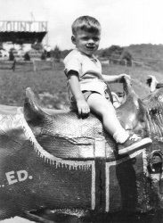 This is me, not quite age two, making like a real cowboy. The photo was taken in 1963 with a Kodak Autographic Junior camera (that I own today, though I can't get it open) probably at the Tweetsie Railroad amusement park in Blowing Rock, NC.
(ShorpyBlog, Member Gallery)