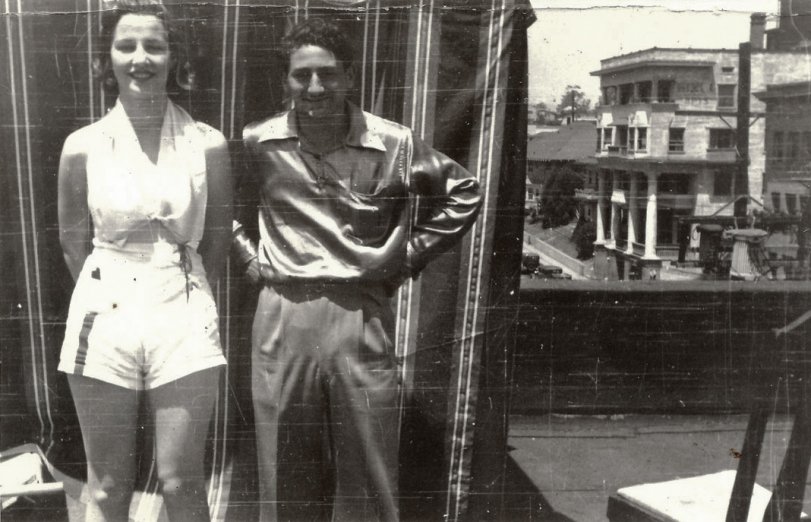 Posing on a rooftop. This time her boyfriend is there. Found in a lot of photos purchased at auction. View full size.

