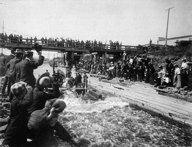The Duke and Duchess of York braving the timber slide at Ottawa during their 1901 tour of the British Empire.  Seated on the crib are the future King George V (who preferred being at home tending his stamp collection), and his wife, the future Queen Mary, after whom the ocean liner, The Queen Mary, was named.  By braving the slide, the Royal couple passed a Canadian test for “pluck”.  The couple’s eldest son would become Edward VIII in 1936, abdicating before the year was out.

Alfred George Pittaway Photographic Studio, 58 Sparks Street, Ottawa. View full size.