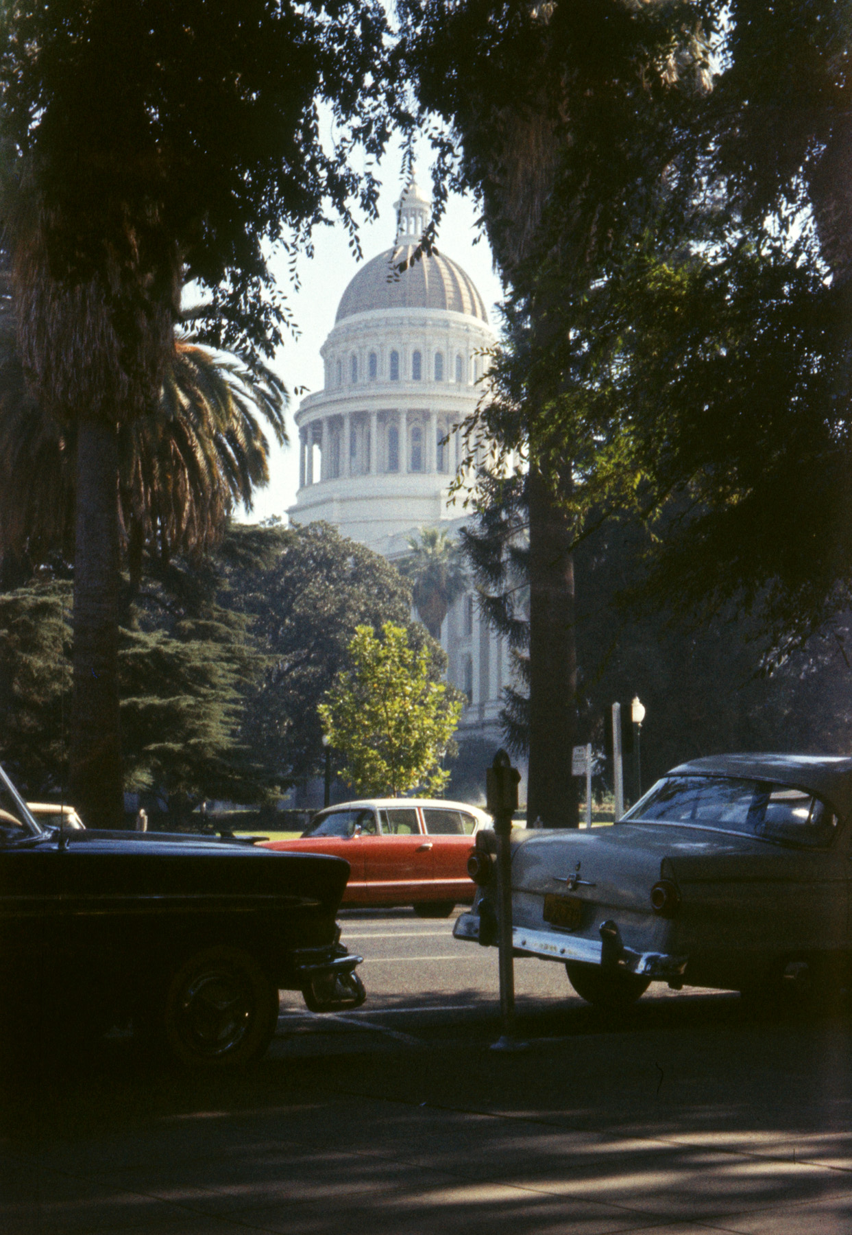 While I didn't take this photo of the California State Capitol - my brother did on 35mm Anscochrome - I am the reason it exists. At 11 years of age I was an avid rockhound and longed to find things like quartz crystals or what was for me the holy grail: a geode. What I lacked was field experience, so I wheedled my father into driving up from Marin County to the American River in the Sierra foothills east of Sacramento. My brother came along for the ride. History does not record, nor did my brother, anything that might have happened past Sacramento. If I'd found crystals or a geode, I'd have remembered. But today I have one consolation: my brother fortuitously captured a Nash in its natural habitat, the roadways of the 1950s. View full size.