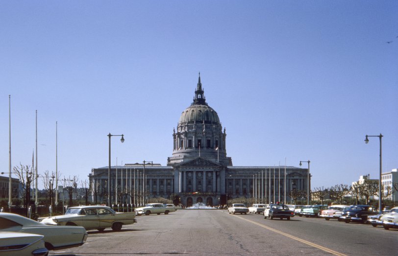 San Francisco City Hall on March 14, 1965. I was with friends to take in the St. Patrick's Day Parade and we apparently tooled around beforehand, giving me an opportunity to take this Kodachrome slide with its smattering of cars, some of them already classics. Back in 1956, Chryslers of that year with their big, luscious tail lights had been among my favorites, and here we have two of them. Among the others, an old bathtub Lincoln, a later-model Thunderbird and a smidgen of a Corvair. If you want to park here now, forget it. Later on at the parade, I took this shot featuring another car, and also a governor. View full size.
