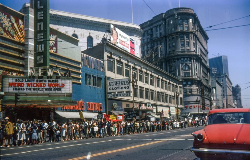 San Francisco, August 6, 1966. International Days of Protest march on Market St. between Powell &amp; Mason. Slide mount is dated August. Is the theater marquee a comment? The Woolworths at Powell &amp; Market is now The Gap. The near buildings along Market are all gone, the area now occupied by Hallidie Plaza. I took this on 35mm Kodachrome. View full size.
