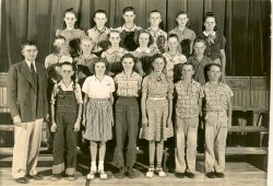 This is a photo of a school class around 1938 in Leon Kansas. The girl Betty, third from left, front row and boy Darrol, far end at right in the front row, next to his twin brother, Harold, were married in 1947 and are parents of my wife, born in 1949. The twins were born in 1927 and are to this day alive, active and well. Betty, her mother is also still alive, soon celebrating their sixtieth anniversary. They now reside in Wichita, Kansas. View full size.
