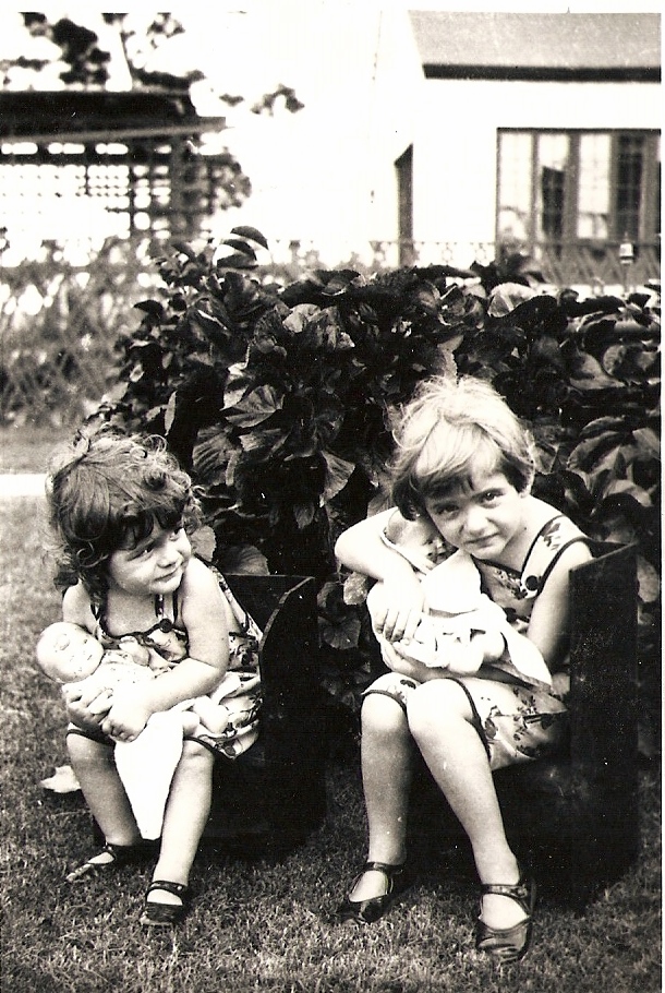 Helen is on the left and Ann is on the right. This picture was taken in 1930, Miami. Ann was four and Helen was about two or three. I love how they are holding their baby dolls. View full size.