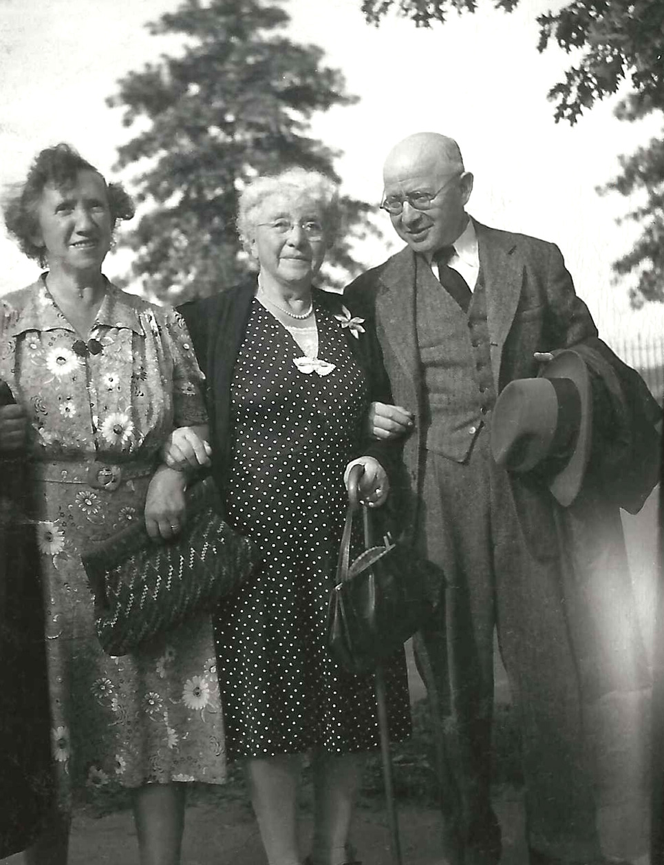Clara survived Theresienstadt and was located by the husband of one of Max’s daughters who went to Europe after the war to find her and bring her to the USA. Here she stands between Jenny (my father’s mother) and her brother Max (who was last seen in a sailor suit posed with a hoop). The exact year of this picture is unknown. I only know that Jenny died in 1959.

Clara came to the USA with her most prized possession: a turn of the century motoring blanket made of horse hair (or some equally scratchy animal fiber) and full of holes. Lap-sized, with an animal spot design, it was truly a wretched object.  But to have any personal possession in a concentration camp was precious. My family still has her blanket. View full size.
