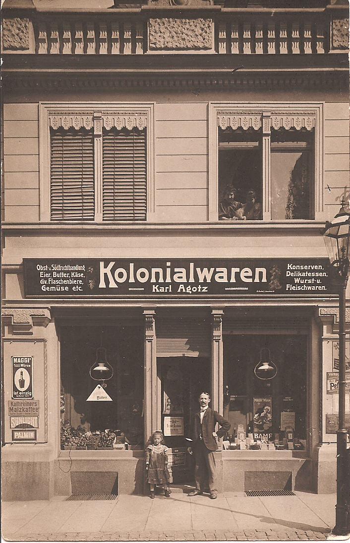 My maternal great grandparents' grocery store in Leipzig Germany. My great grandfather and great aunt in front of the store, and my great grandmother and grandmother peeking through the window above. 

Shot as a postcard by "Leipziger Bromsilber Postk.-Fabrik BROMOPHOT,  H.Jahn, L.-Kl.-Zschocher, Bahnhofstrasse 4. View full size.
