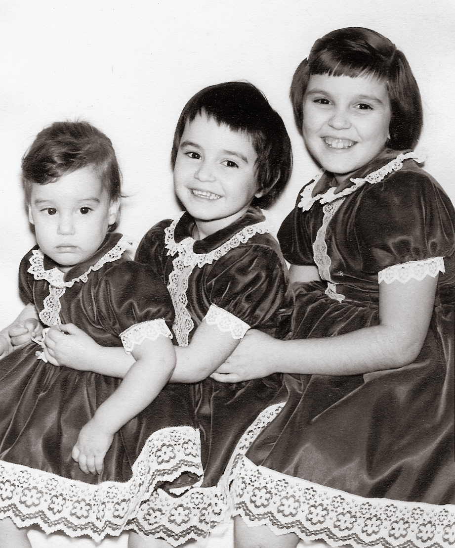 This is a photograph of me and 2 of my 4 sisters.  I am the youngest, Diana is in the middle, Linda is the oldest. It was taken in 1962.  My grandmother was a seamstress and would make us matching outfits. View full size.