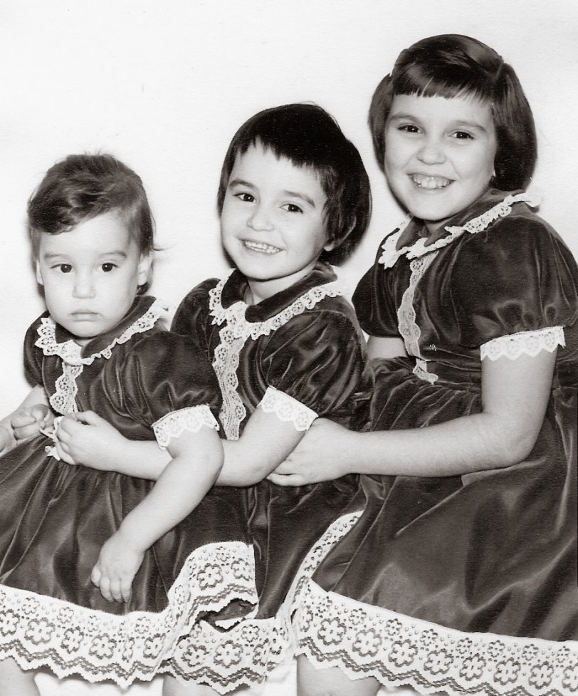 This is a photograph of me and 2 of my 4 sisters.  I am the youngest, Diana is in the middle, Linda is the oldest. It was taken in 1962.  My grandmother was a seamstress and would make us matching outfits. View full size.
