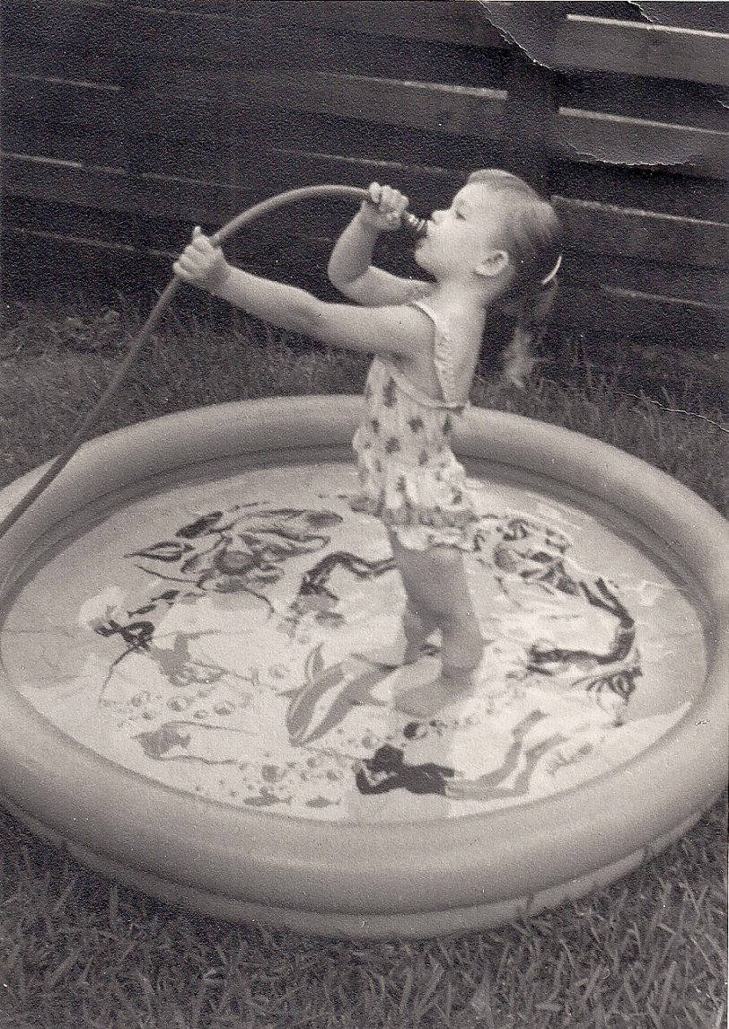 I was only three but I remember that the water was just barely trickling out of the hose. However, seeing this photo used to give me bad dreams of having a hose in my mouth and some mean person suddenly turning the water up full-blast! View full size.
