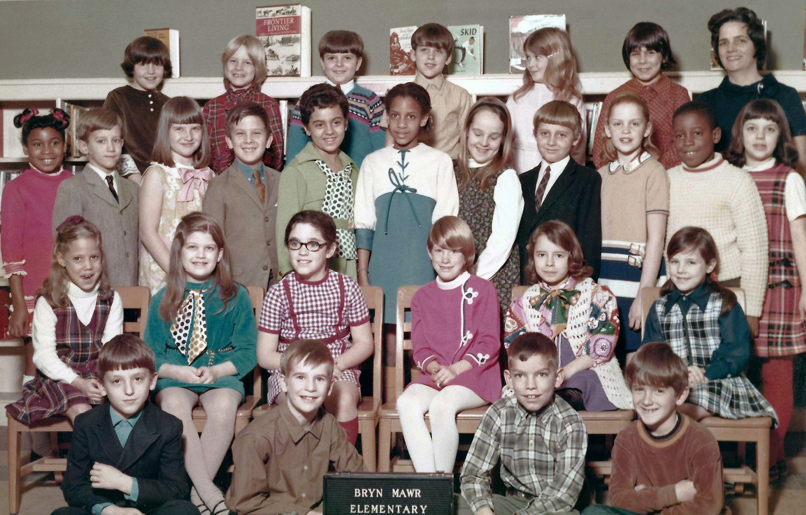 My brother Iden, sits on the far left of the first row in his 1970 third grade class picture. And though these photos were taken by a professional photographer, I have to question just how professional this one was. I did not cut the identifying sign off in scanning this picture. It was not in the print. View full size.
