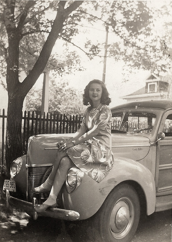 This photo was taken in Shrewsbury, MO, around 1945. My mother is about 17 years old and is sitting on the fender of my grandfather's Ford station wagon. I vaguely remember this car. I don't know who dented the fender but the front tire is bald. My grandfather traded this car in on a used 1948 black Chevrolet tudor sedan. View full size.