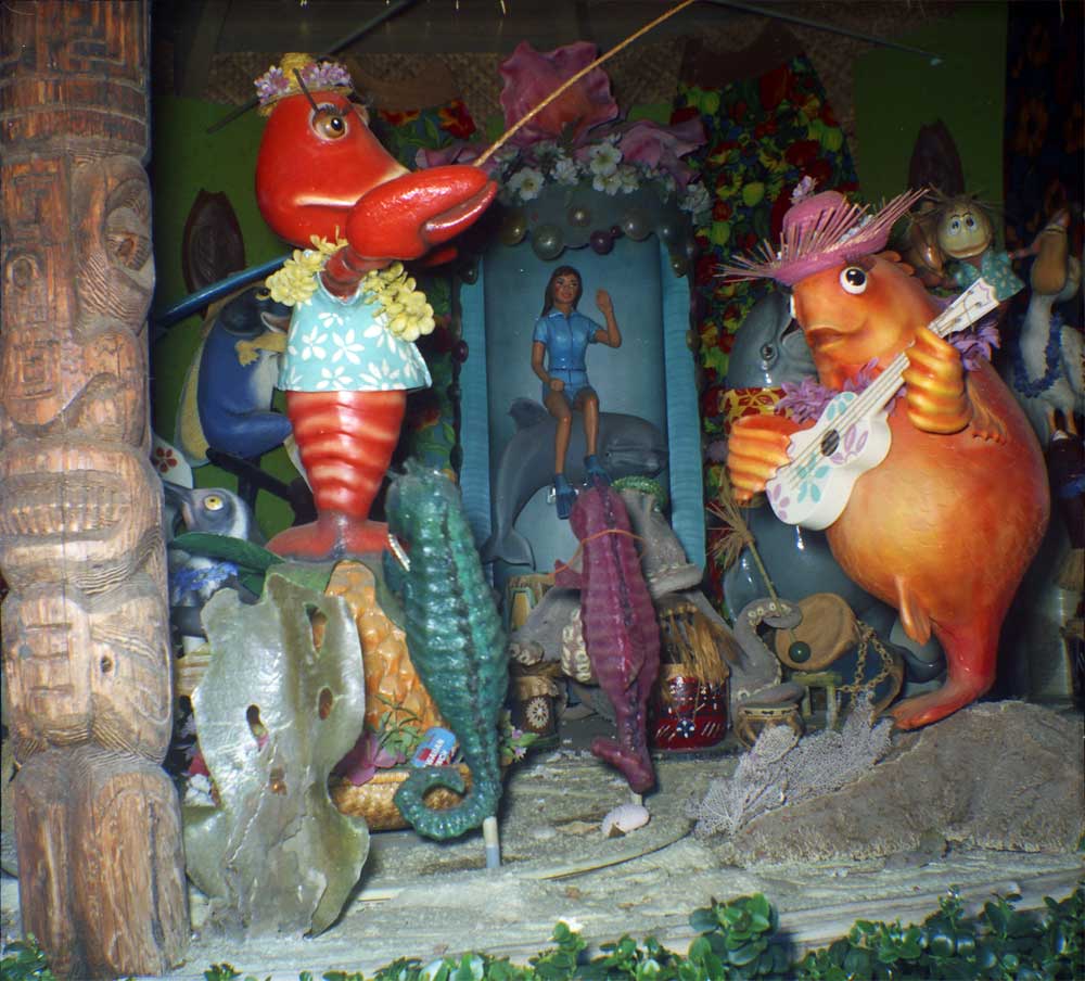 Between the freaky looking orange guitar playing fish, the scary dolphin behind it, the wide-eyed penguin on the left and the lobster with eyelashes in front of it, this photo is just a little bit creepy. Also notice the Hawaiian Punch near the bottom. 

Scanned from a Kodak safety negative. View full size.