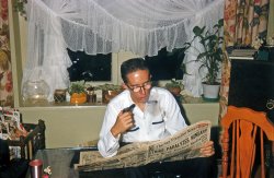 November 22, 1956, Larkspur, Calif. My brother reading The San Francisco News, at the time one of four dailies published in the city. He's home on Thanksgiving break from Cal Poly, where he'd just taken up the pipe. We're hosting a big crowd of relatives for dinner, hence the kitchen chair in the living room for overflow dinner seating. In the upper right corner on top of the TV cabinet I see my coin collection, ready for me to show off to my uncles and anybody else I can waylay. At the lower left, an item familiar to just about anybody who grew up in the 50s, an anodized aluminum tumbler. The magazine rack has a Coronet, a Life, undoubtedly some Saturday Evening Posts. To prove we're in California, a souvenir redwood wishing well coin bank on the window seat, along with my mother's African violets in their occasional living state. My sister snapped this Kodachrome slide with brother's Lordox. View full size.