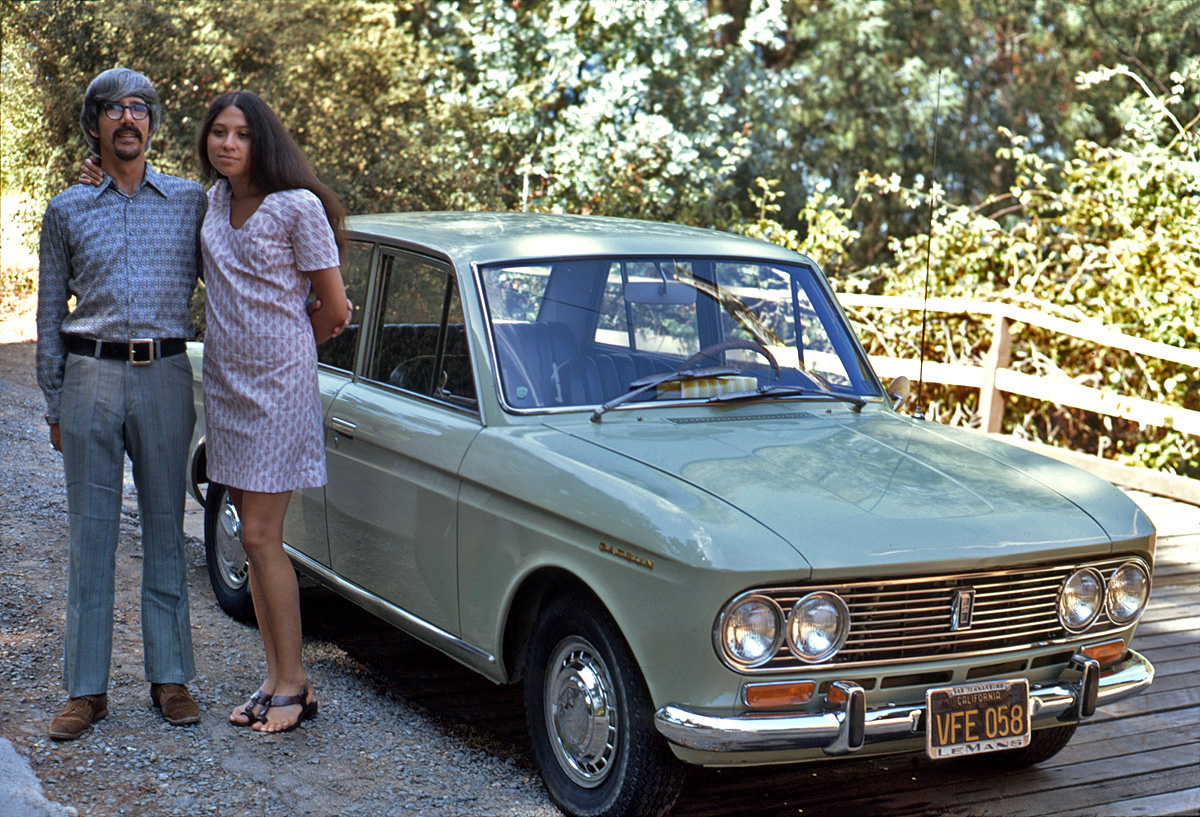 August 1971. A car that today you'd most likely see as a rusting hulk in a junkyard or vacant lot, and clothes in a Goodwill. My brother and sister-in-law pose with their 1967 Datsun Bluebird parked on my father's garage ramp on Walnut Avenue in Larkspur, California. All kidding aside, I think they're both pretty snappily dressed, and her expression is pricelessly inscrutable. My Kodachrome slide. View full size.