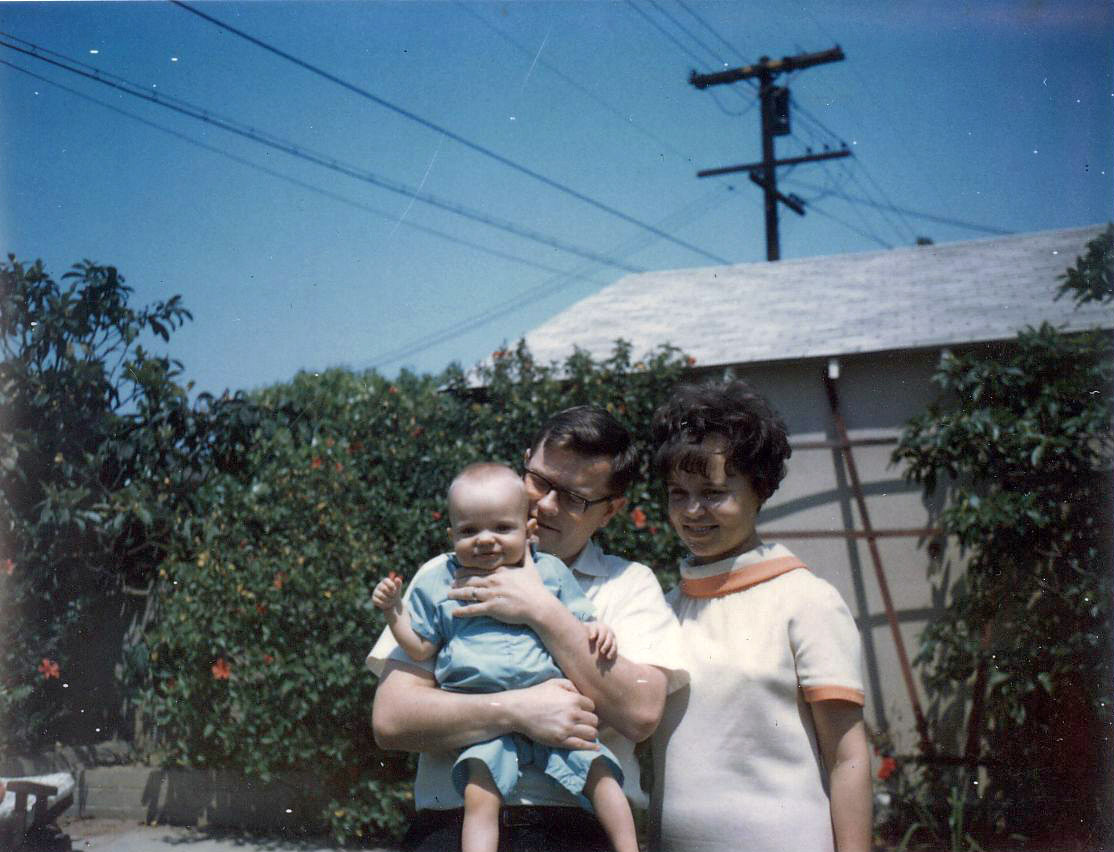Yes that is me (the short one with the puffy cheeks)with my proud parents on Mother's Day 1967. Likely taken at my aunt's house somewhere in the San Fernando Valley. I have more hair on my head back then than I do now! View full size.