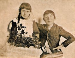This photo was one in a box of about 200 given to me by a friend who found them abandoned in a home that was being gutted. It was a phenomenal treasure trove of images that run from the 1860s to the late 1950s. This particular image is on a roughly hand cut piece of photographic paper that seems to have missed being adhered to cardboard somehow. I'm guessing this to be anywhere from around 1885 to 1900. I love her shamrocks.