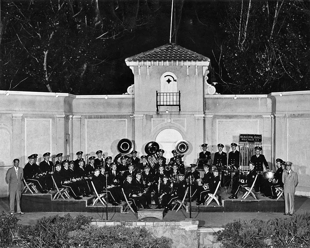 I've established that music was a life-long pursuit for my grandfather, from his youth in New Hampshire to his final days in North Carolina. But someplace in the middle, he and my grandmother spent a number of summers in South Dakota. This picture of the Sioux Falls Municipal Band dates from 1949 or 1950. 

Here's the line-up for the band, by tier: 4) Ed Paul (standing), Gossman, Smith, Hoover, Branch, Susede (?), RIchardson. Ellis, Jackson, Friedhoff, Alger, Pruner, Marker, Niblic (?), Kittleson, Miller, Henegar. 3) Madeck, Littlehang, Barnett, Askew, Little, Anderson, Lorenson (?), Brooks, Krumrai, Ewing. 2) Larson, Pace, Colwell, Hanson, Hoyt, Weber, Richardson, Wagner, Morgan, Griffith, Lias. 1) Palmer, Tyler (my grandfather), Olsen, Foss. Tietjen (Standing at right?) Cor. not in picture. View full size.