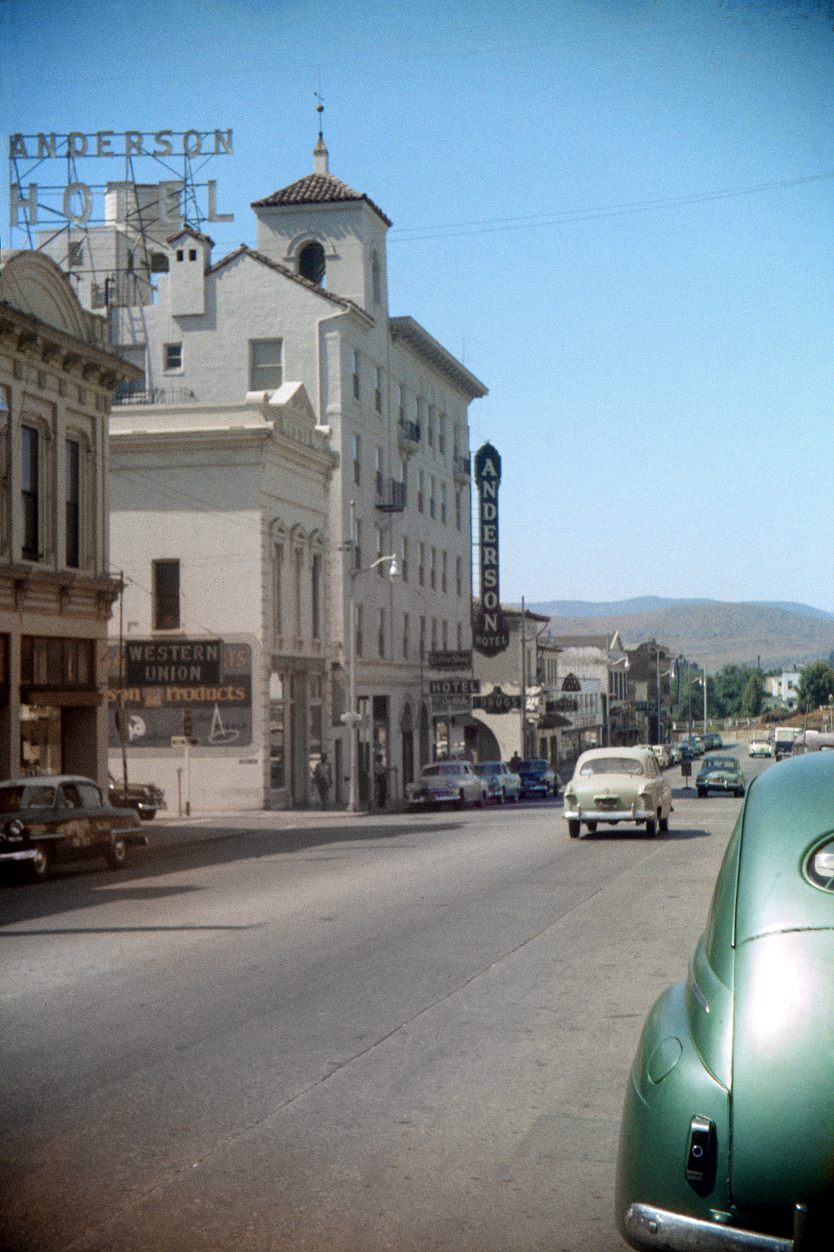 Summer 1955, San Luis Obispo, California. The days when old-looking buildings downtown really were old and Studebakers could roam the streets freely. My brother's Anscochome slide. View full size.