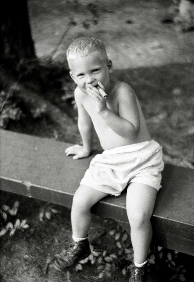 They sure started young smoking back in the day. From my negatives collection. View full size.
