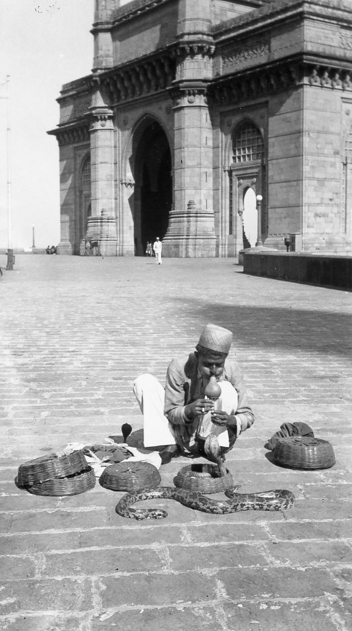 Snake charmer at Victory Gate, Bombay, India, 1939. View full size.
