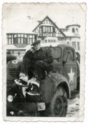 Walter on his Dodge tipper, outside the Belgian Chateau they were billeted at somewhere near Boom, between Brussels and Antwerp. Winter 1944.
Quiet Mike: "You said you were in Antwerp for Christmas?"
Walter: "I went to stay with my friends at Estelle’s. I went up there, we’d got a wagon, a liberty wagon, and we went up to somewhere not far from Fort Seven, I can’t think of the name of it. It was by Fort Seven. Then I’d got a tram into the city and went to see my friends, and it was bad weather, it was snowing. I left Estelle's, early enough, and got the tram back, but there was some sort of hold up, and when I’d got back the liberty wagon had gone. So, I didn’t really know what to do, and it was snowing as well. I got back onto the road, and was walking back. I didn’t know what I was going to do mind you.
"Anyway I started walking back, and looking around all of I sudden I saw headlights. I waved him down, and it was my mate. It was our dispatch rider, George Rand. I couldn’t believe it! He’d pinched a truck and gone up into Antwerp. It was my good fortune really. I stopped him and got in. He drove us to the gate and parked it by the side of the road. I said 'Are you on duty?', 'No, I borrowed it.' Good for me, and I got back in time." View full size.
(ShorpyBlog, Member Gallery)