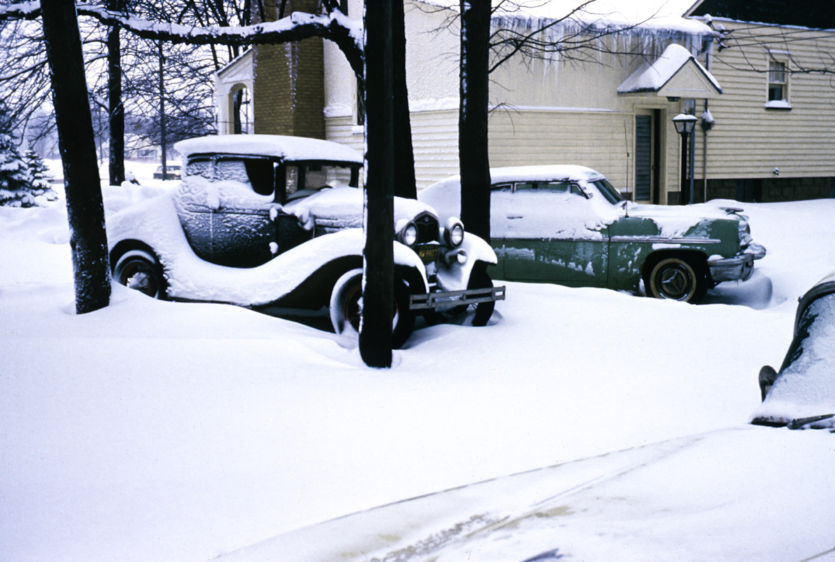 The house in the background is my great grandparents, in snowy Michigan. The Model A and Mercury are both my Grandpa's cars. He graduated high school in 1954, which is when this photo was taken. He still owns the Model A, which is now restored. View full size.