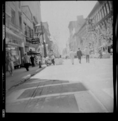 Another photo taken in 1960, when I was 4, with my Kodak box camera. This is looking west on Sparks Street, in Ottawa. You can see the sign for the Hardy Arcade which is now a heritage site. Sadly, it is but a shadow of its former self, having been encased in the new CBC (Canadian Broadcasting Corp.) building. The camera lasted many years, despite having filled with sand in a very windy day at the beach later that summer. It made a grinding sound when you clicked the trigger but worked just the same.
Again, not a sharp image. View full size
(ShorpyBlog, Member Gallery)
