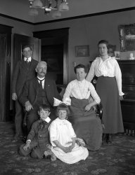San Francisco, 1914. My mother's family and their chandelier posed for a portrait shot on a 5x7 glass plate in their home at 1834 15th St. On the floor, my mother and her twin brother Albert. Seated, John and Marie. Standing to either side, Francis and Mary. View full size.
