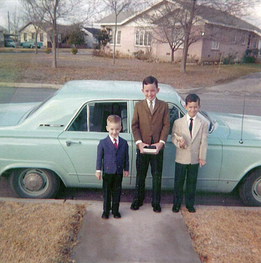 My older brothers and me about 1964, off to Sunday school in Austin, Texas. Can anyone identify cars in fore and background? And if memory serves me I do believe those are all clip on ties. And being the youngest, there was no guessing as to what I would be wearing to church in the coming years. View full size.