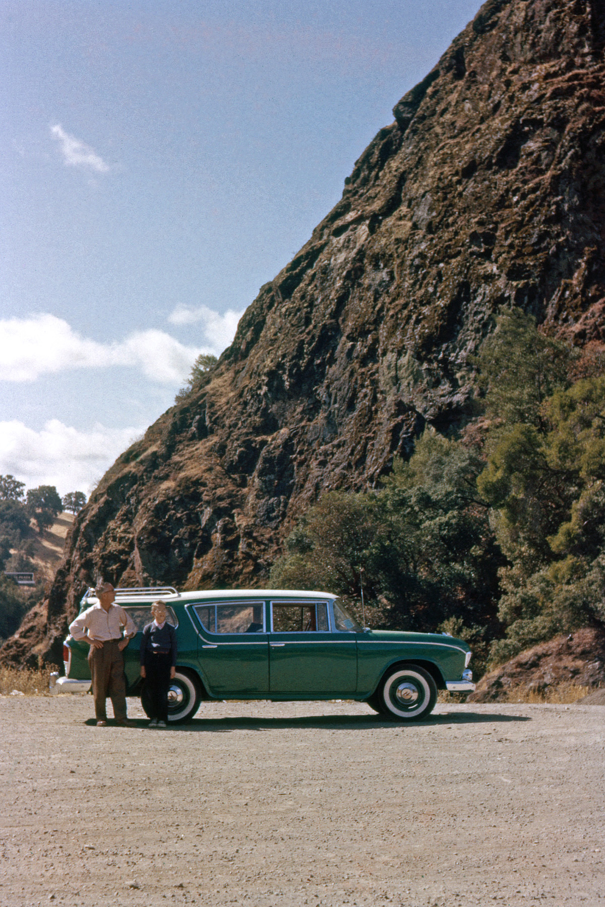 September 1956. My father, me and the new Rambler on its first long ride, at Squaw Rock on U.S. 101 south of Ukiah, California, captured by my brother on Ektachrome. Could almost be a new card ad, except I'm not running around laughing hysterically. View full size.