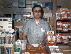 Found a slightly older photo to the one seen here. Believe this was taken in 1971 (I'm going by the candy prices) also by my brother and a Polaroid Swinger. This is Dad standing dutifully at his and Mom's Luncheonette in Passaic, NJ. Man, I ate a lot of that Lance peanut brittle! View full size.
Color Swinger?Sure about that shot?
I don't seem to remember anything but B&amp;W film for the Polaroid Swinger.
And I am just remembering now the little tube of fixer that came with each film pack.
And Caravelle bars.
Ahem...Man, I ate a lot of those Lance snacks too! :P
swinger?never was color film ever made for it...just to let you know..nice image with great details
CloretsMy mother ALWAYS had Clorets in her purse. She never ran out!
Where are the Baseball Cards?Did the store have Baseball cards?  Didn't see them in either photo. I'm sure you'd remember though exactly where they were.
Emulsion SacrilegeAll this talk about Polaroid film, when the counter protector clearly says "Don't forget Kodak film"!
My two favoritesFront and center are my two favorites, namely Andes mints and Chunky.  The only place I see them together these days is at Cracker Barrel.  
Thick...Rich...Chunky! "Open wide for Chunky!" Another unforgettable jingle.
Candy"Chunky...What a chunk of chocolate!"
Hacks Cough DropsWhat ever happened to Hacks brand cough drops? There is
nothing quite like a foul-tasting cough drop to make you forget about your runny nose and congestion! 
Re: Clorets"Tastes like a mint -- works like a miracle!"
Wrong taglineRolaids was "Tastes like a mint..."
Uncle JoeWowzers.. My Uncle Joe ran a "candy store" that looked just like this.. six miles East of Passaic in Palisades Park. Bet there were about ten NYC newspapers lined up in front of the counter. 
Granddad&#039;s Advice"Never say NO when someone offers you a Clorets!"
The name was based on the chlorophyll added to freshen breath. You don't see it so much in the States these days, but it's big in the foreign markets, especially Mexico, Japan and the Middle East. 
1948/19871948, the year I started smoking. 1987, the year I quit. Your dad's right elbow pointing to Marlboros, the brand I was smoking then.
Going Back in Time nowAleHouseMug and rizzman1953 you are right there was no color film for the Swinger, my mistake.  This was taken with his Polaroid 150 on type 48 film.
Dad loved photography but also instant gratification which is why he kept Polaroids around.
Scott in the Bay, Baseball cards would have been screen left on the other side of the candy display.  I only remember him carrying them at the start of the season though and seldom did he restock after the first batch were gone.
Think I'll go home and make a chocolate malted now!
&quot;Cloretscost a little more, but Clorets do so much more."
As I recall, the name came from chlorophyll and retsyn. 
Lance Peanut Butter LogsIsn't that what they were called?  And I was addicted to them also.  I bought so many that the guy at the neighborhood drugstore told me I'd save a lot by buying a case at the time, so I started doing that.
(ShorpyBlog, Member Gallery)