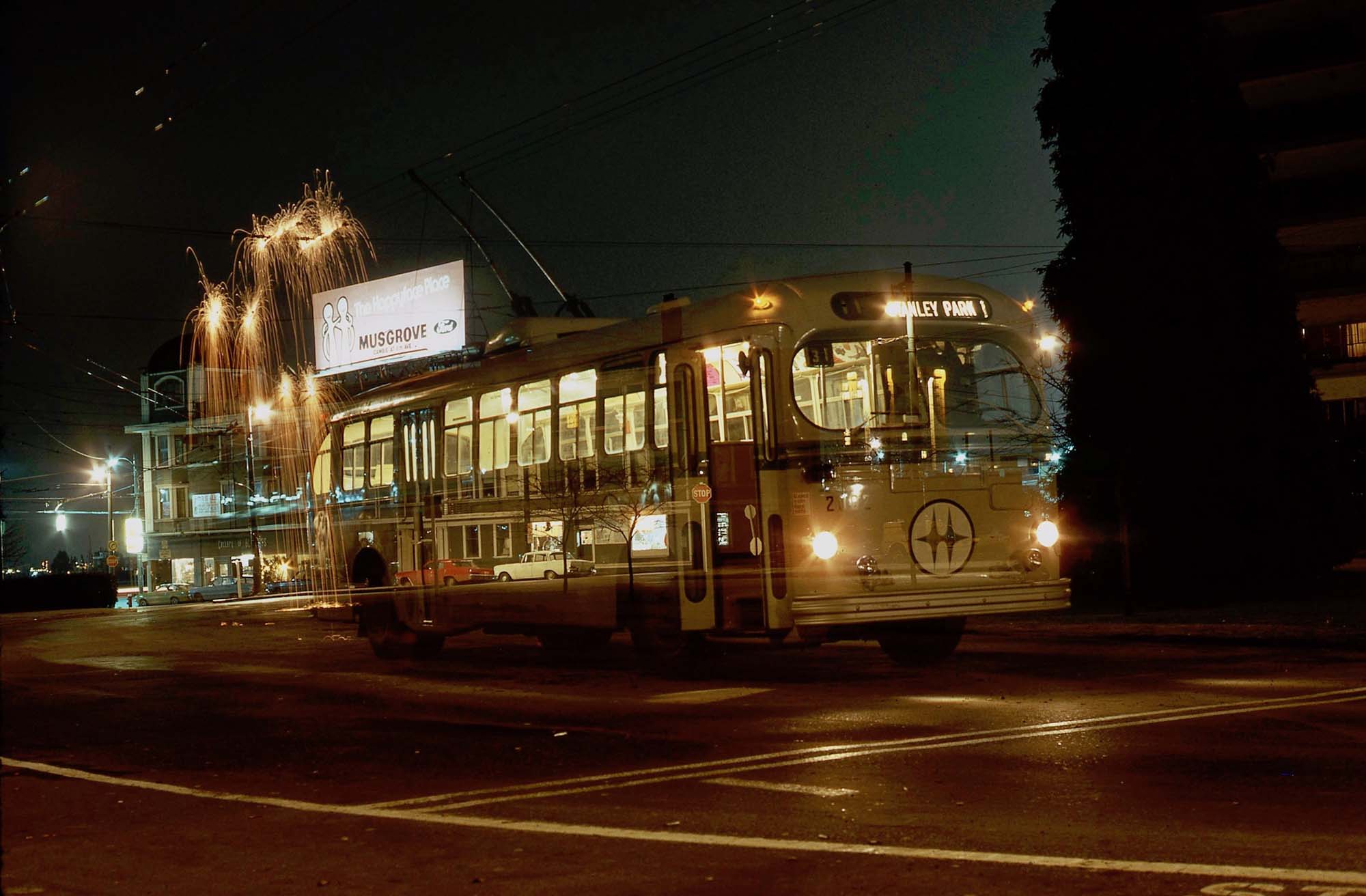 I took my camera and tripod to work one night in 1974 as a Vancouver trolley bus driver. This is a photo at the old (Chilco Street) Stanley Park Bus Loop with a 1948 Brill trolleybus. 

In the background, and through the bus, you can see the Stuart Building, which was illegally demolished at 4 am a few years later. To obtain this shot, the camera was placed on the tripod, and the shutter was locked open. With all the bus lights turned off, the bus was originally parked at least a bus length further back. 

The reason for all the sparks is this was a passing wire in the loop that was rarely used, and so the metal curve segments on the trolley wires oxidise, and if you power through them you get some great sparks. I pulled the bus forward, created the sparks, and parked it, turned on all the bus lights, and continued the exposure long enough to capture the image of the bus. But not for too long, as I wanted the Stuart Building to show through. So it was a single exposure, although it looks like a "double exposure". I used a Konica Autoreflex 2 camera with Kodachrome film. The loop had incandescent street lights.
