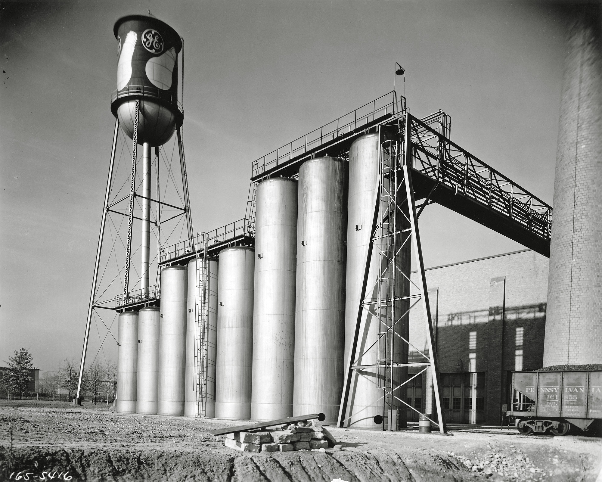The tank farm, where chemicals are received and stored for use in the processing of tungsten metal, at a General Electric plant on the east side of Cleveland, Ohio. From a 5 x 7 glass negative taken shortly after the plant opened in the spring of 1932. View full size.