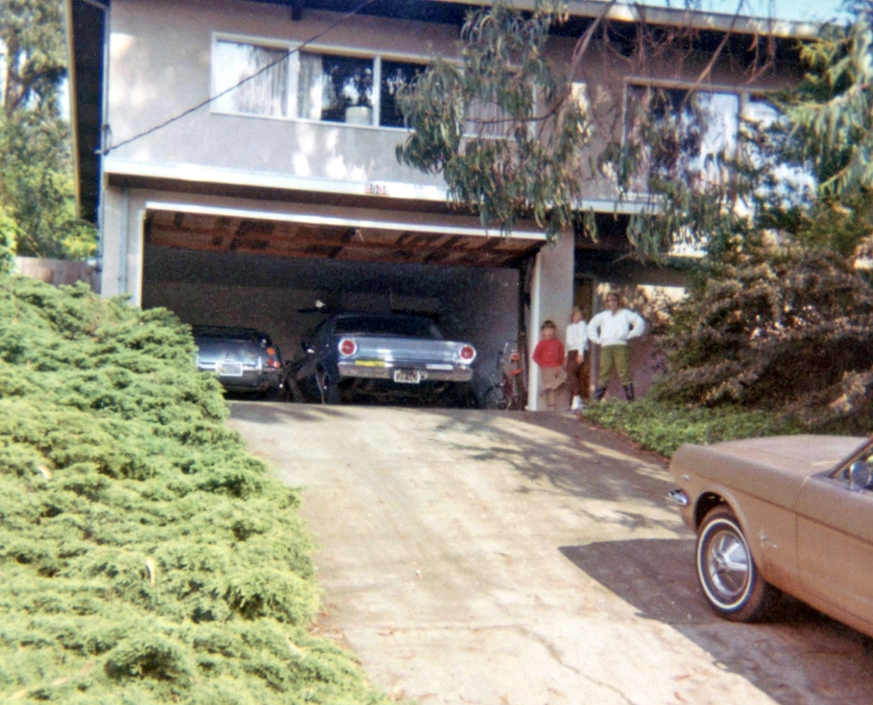 We lived in three different homes in the San Francisco East Bay hills between early 1963 and summer 1988 and this is the third house. (The first can be seen in the 1964 photos I posted with the '58 Cadillac in them.)  1967 and '68 were big years for my family as my dad came into an inheritance and bought this house and a new Austin-Healey 3000 Mk. III, also posted previously.  The front yard had two tall eucalyptus trees that had been poorly topped several years before we moved in and the trees would snap large limbs that would come crashing down in storms.  That drooping limb in the photo came down one windy and rainy Saturday in 1980 and just missed my buddy's '66 Chevelle that was parked in the driveway.  I do miss the sound of acorns dropping on the flat tar-paper roof and the smell of eucalyptus oil.  That's me and my two older sisters posing by the garage.  Mom's '66 Falcon next to dad's Healey and my aunt's '65 Mustang coupe there in the driveway. View full size.