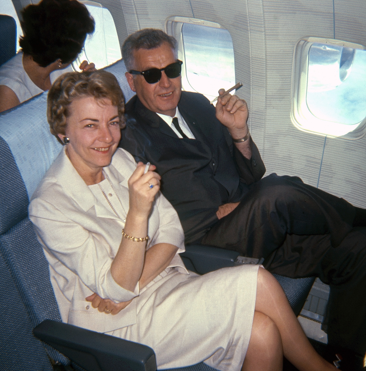 My friend's folks stretch out and light up on a nice, comfy flight from San Francisco to Hawaii in 1965. Someone borrowed their Kodak Instamatic for this 126 Kodachrome slide. View full size.
